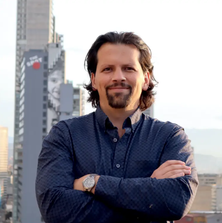 A headshot at Daniel Rangel standing with his arms crossed, looking directly at the camera.